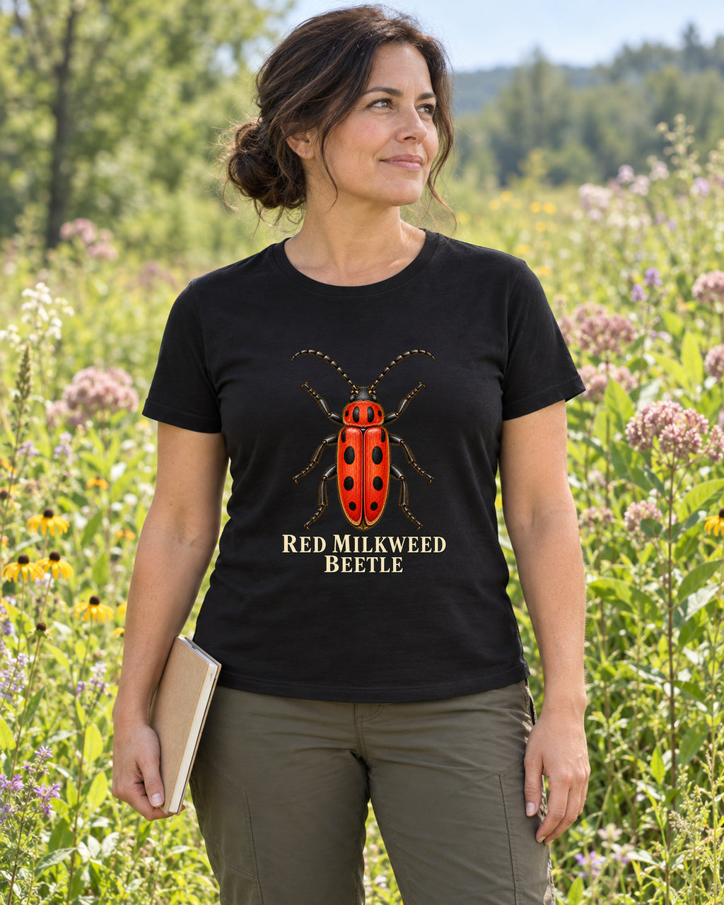 Red Milkweed Beetle Entomology T-Shirt in black, shown in an illustrative lifestyle mockup.