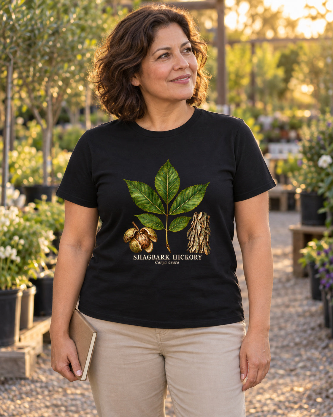 Shagbark Hickory Botanical Study T-Shirt in black, shown in an illustrative lifestyle mockup.