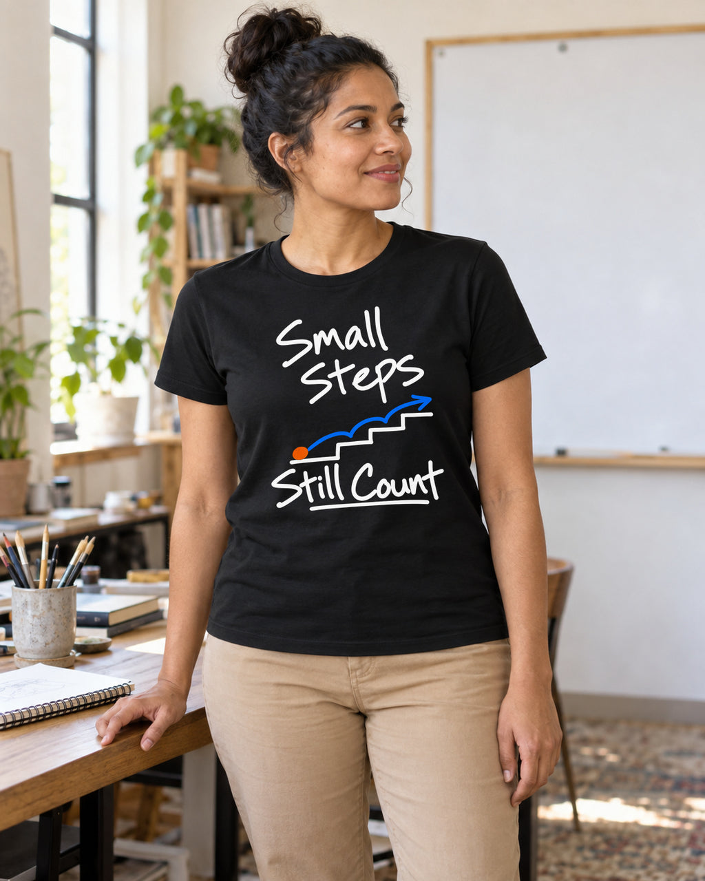 Illustrative lifestyle mockup of the small steps graphic T-shirt.