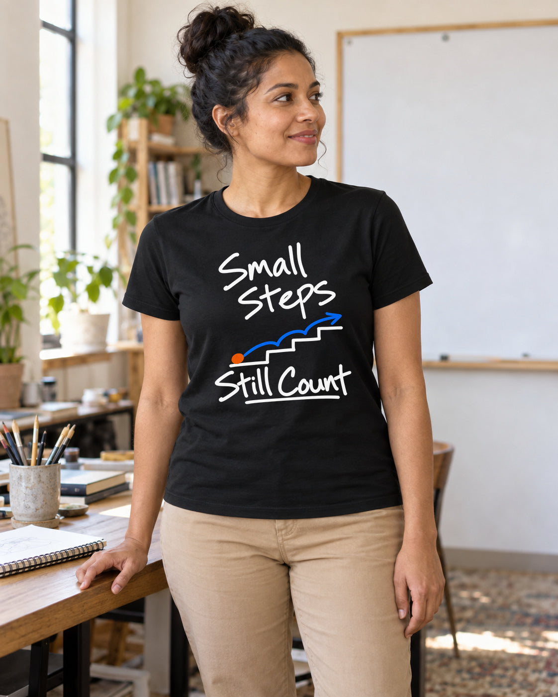 Illustrative lifestyle mockup of the small steps graphic T-shirt.