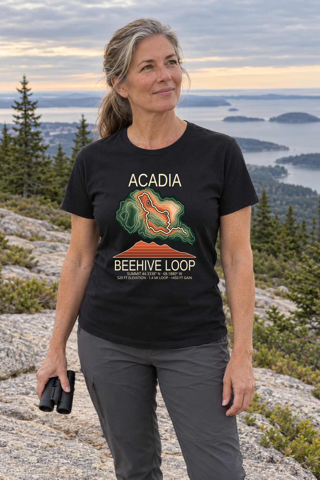 Illustrative lifestyle mockup of Beehive Loop Hiking T-Shirt | Acadia on a black shirt in a generated outdoor scene.