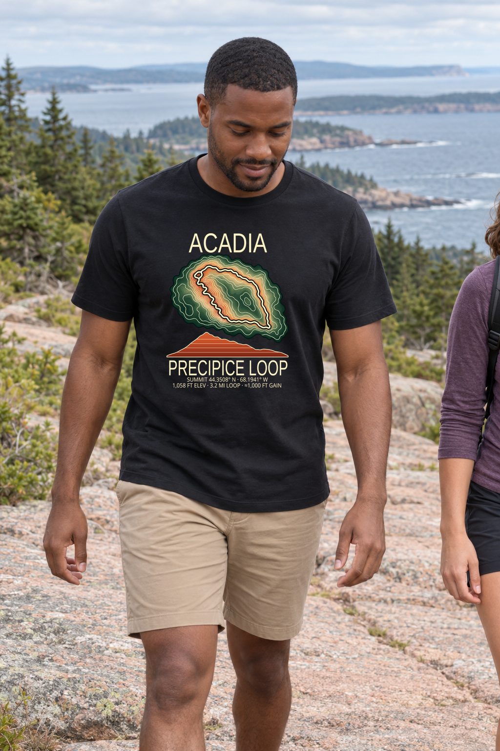 Illustrative lifestyle mockup of Precipice Loop Hiking T-Shirt | Acadia on a black shirt in a generated outdoor scene.