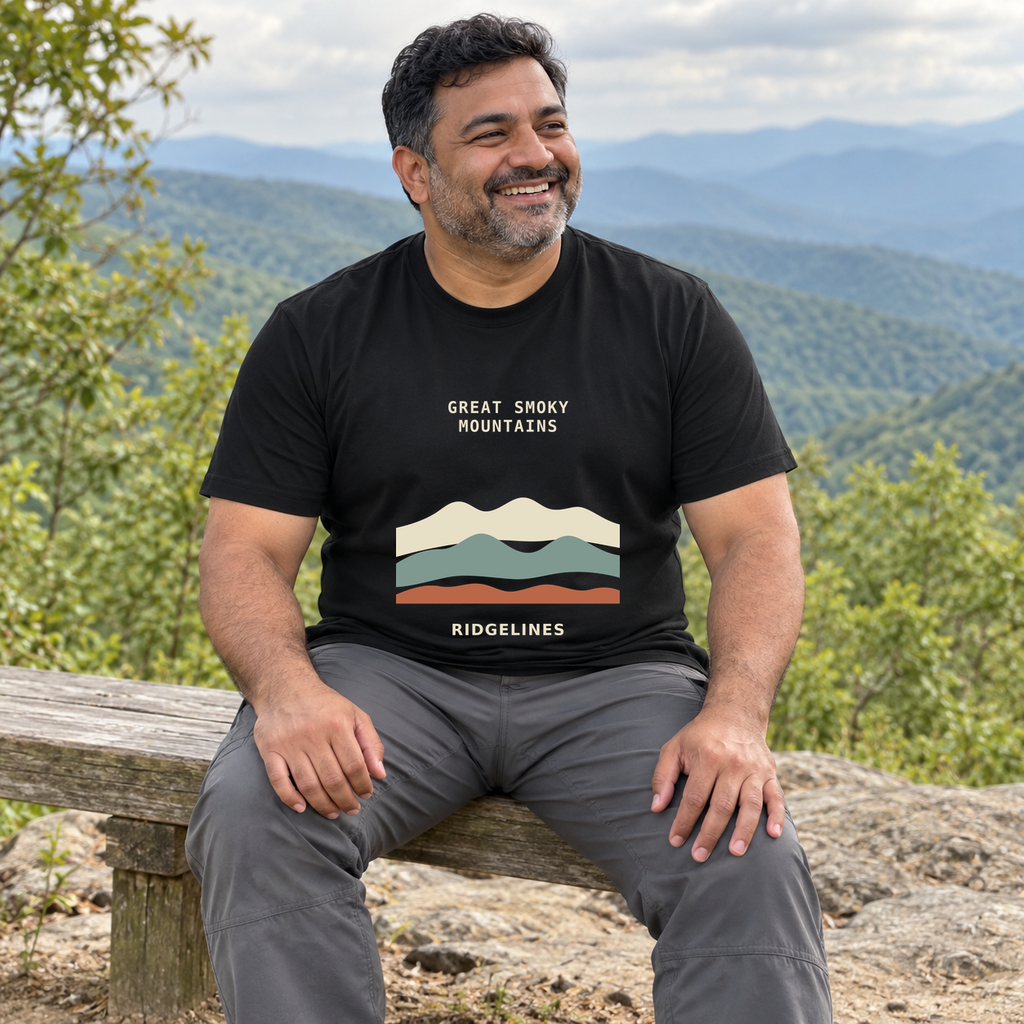 Illustrative lifestyle mockup of Great Smoky Mountains Ridgelines Graphic T-Shirt on a black shirt in a generated outdoor scene.