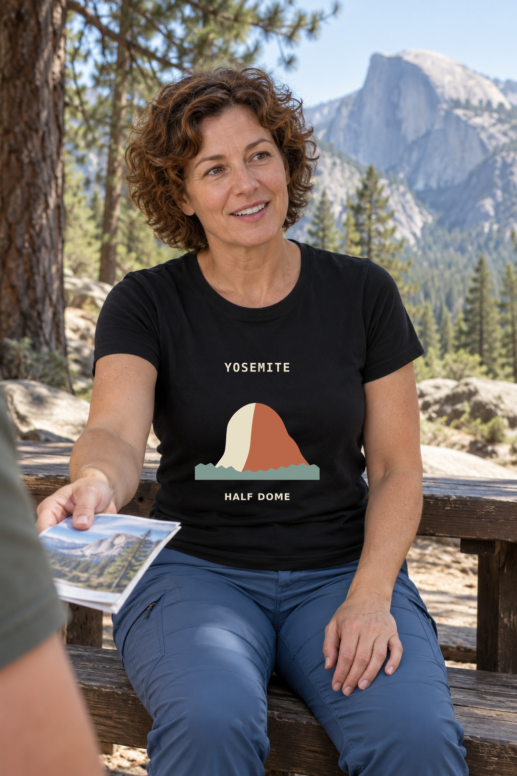 Illustrative lifestyle mockup of Half Dome Mountain Graphic T-Shirt | Yosemite on a black shirt in a generated outdoor scene.