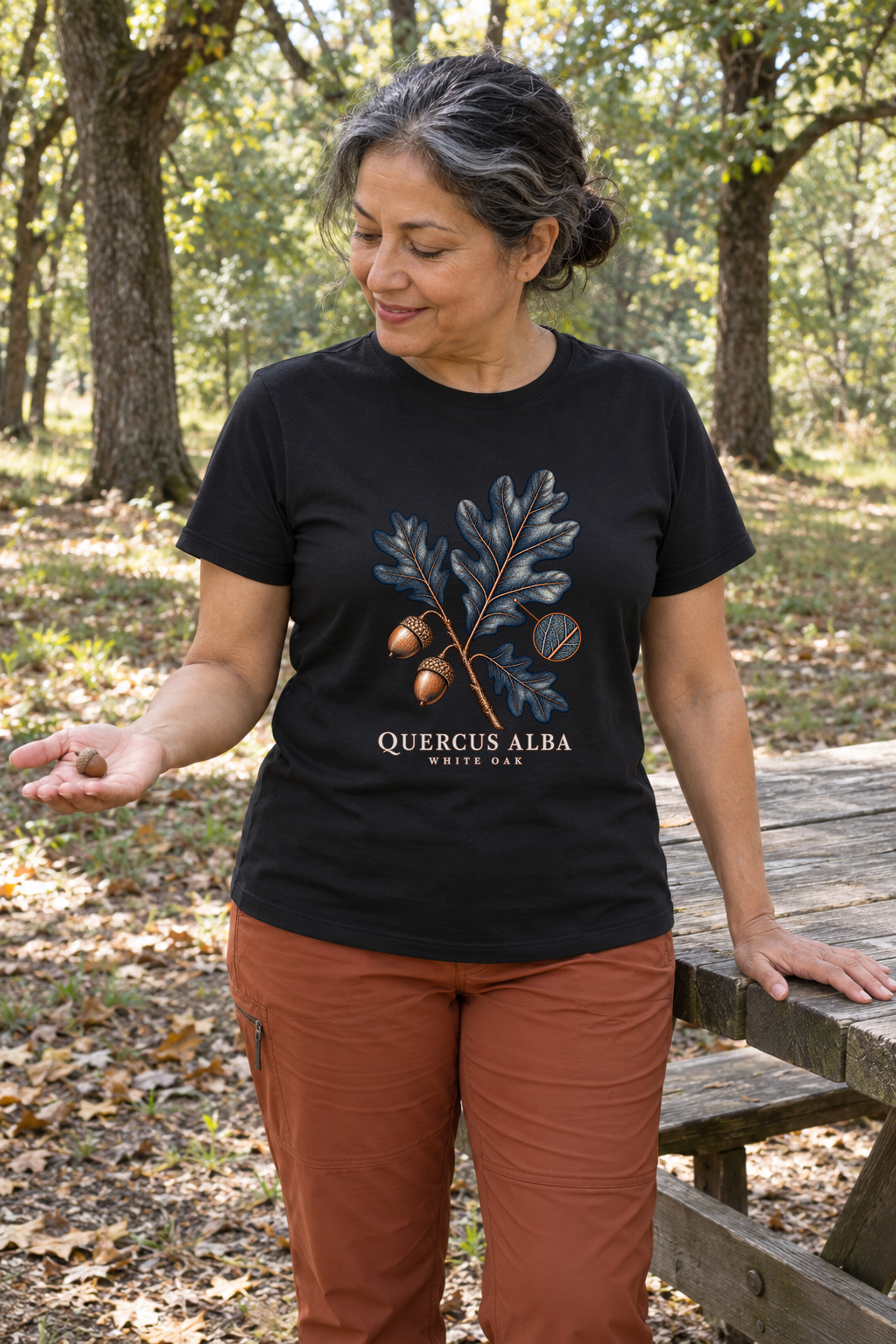 Illustrative lifestyle mockup of White Oak Botanical T-Shirt | Quercus alba on a black shirt in a generated outdoor scene.