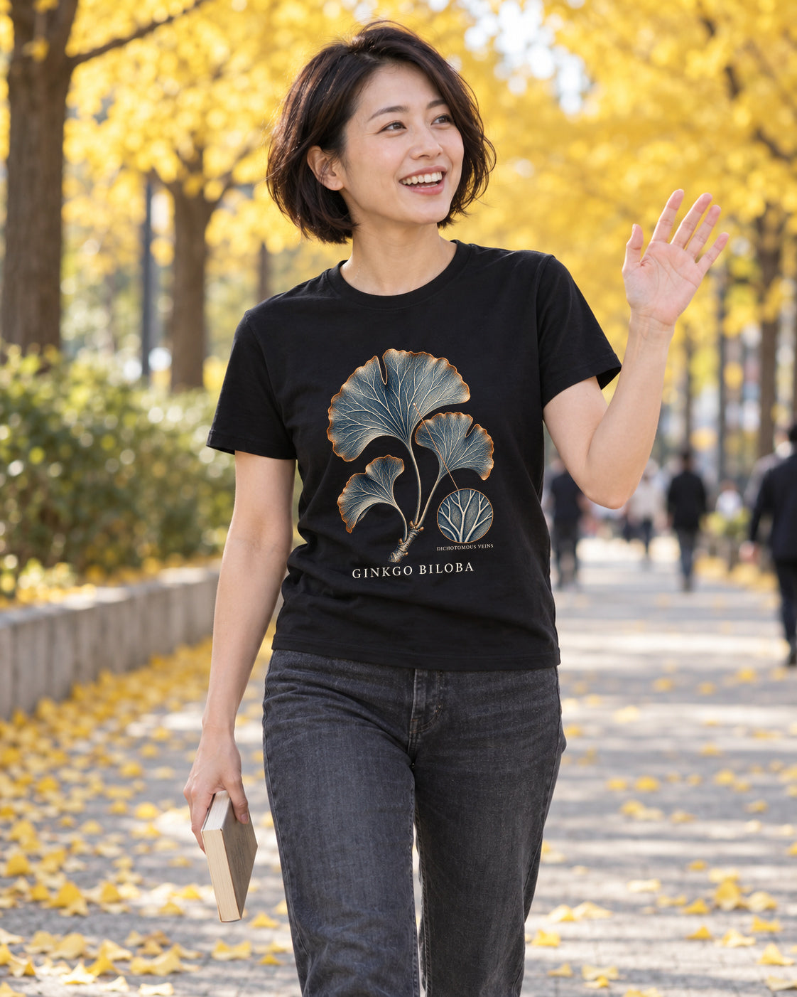 Illustrative lifestyle mockup of the Ginkgo Biloba Leaf Botanical T-shirt on a black shirt in a generated outdoor scene.