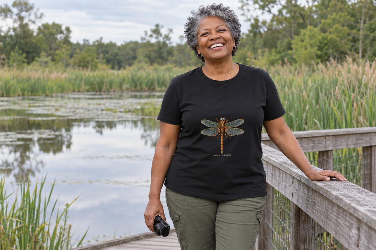 Illustrative lifestyle mockup of the Common Green Darner Dragonfly T-Shirt on a black shirt in a generated scene.