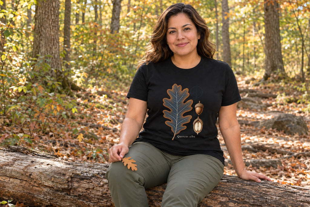 Illustrative lifestyle mockup of the White Oak Leaf & Acorn Botanical T-Shirt on a black shirt in a generated scene.