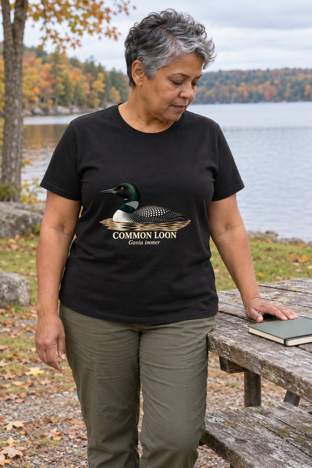 Illustrative lifestyle mockup of the Common Loon Natural History T-Shirt on a black shirt in a generated scene.