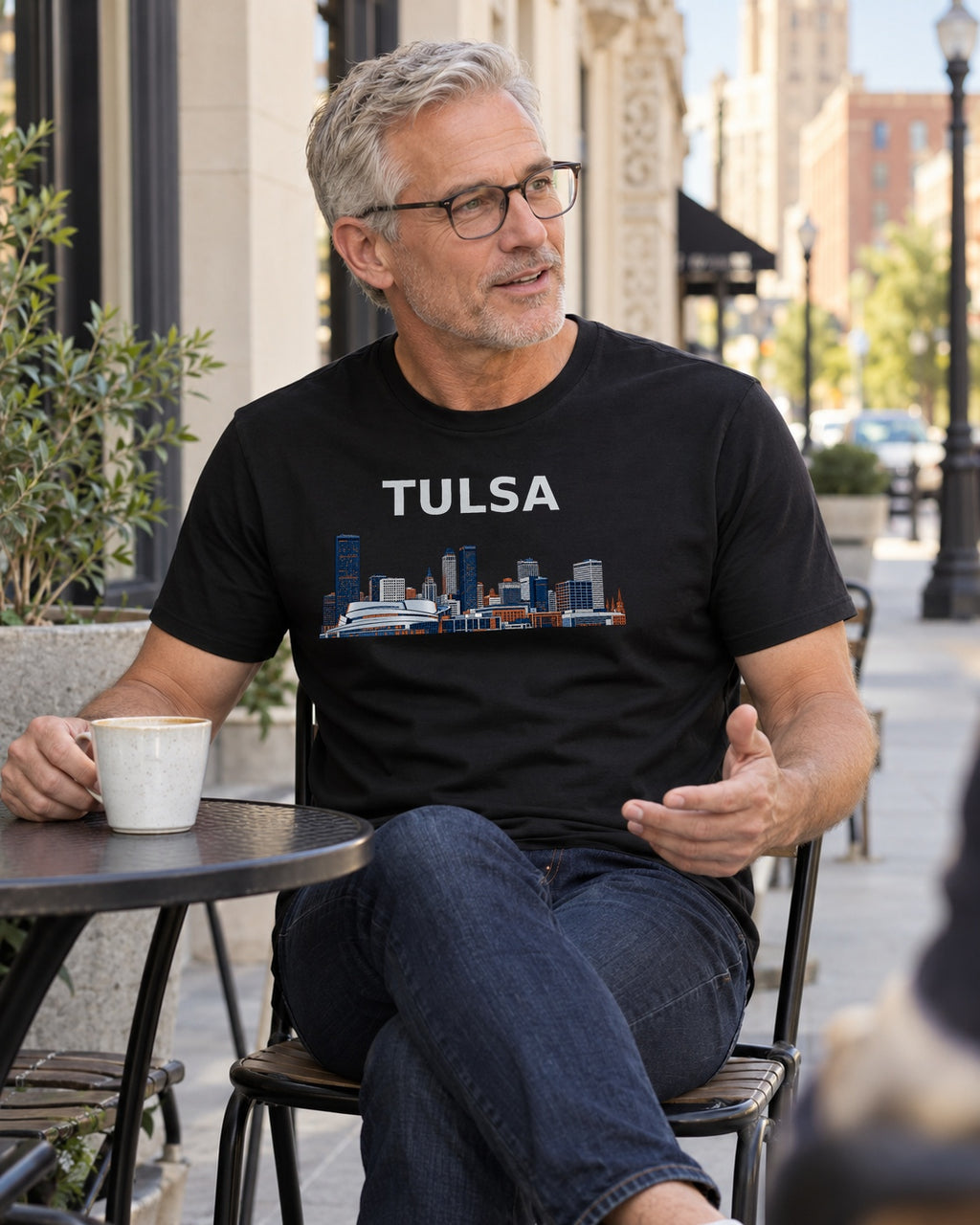 Illustrative lifestyle mockup of the Tulsa Skyline Architecture T-Shirt on a black shirt in a generated scene.