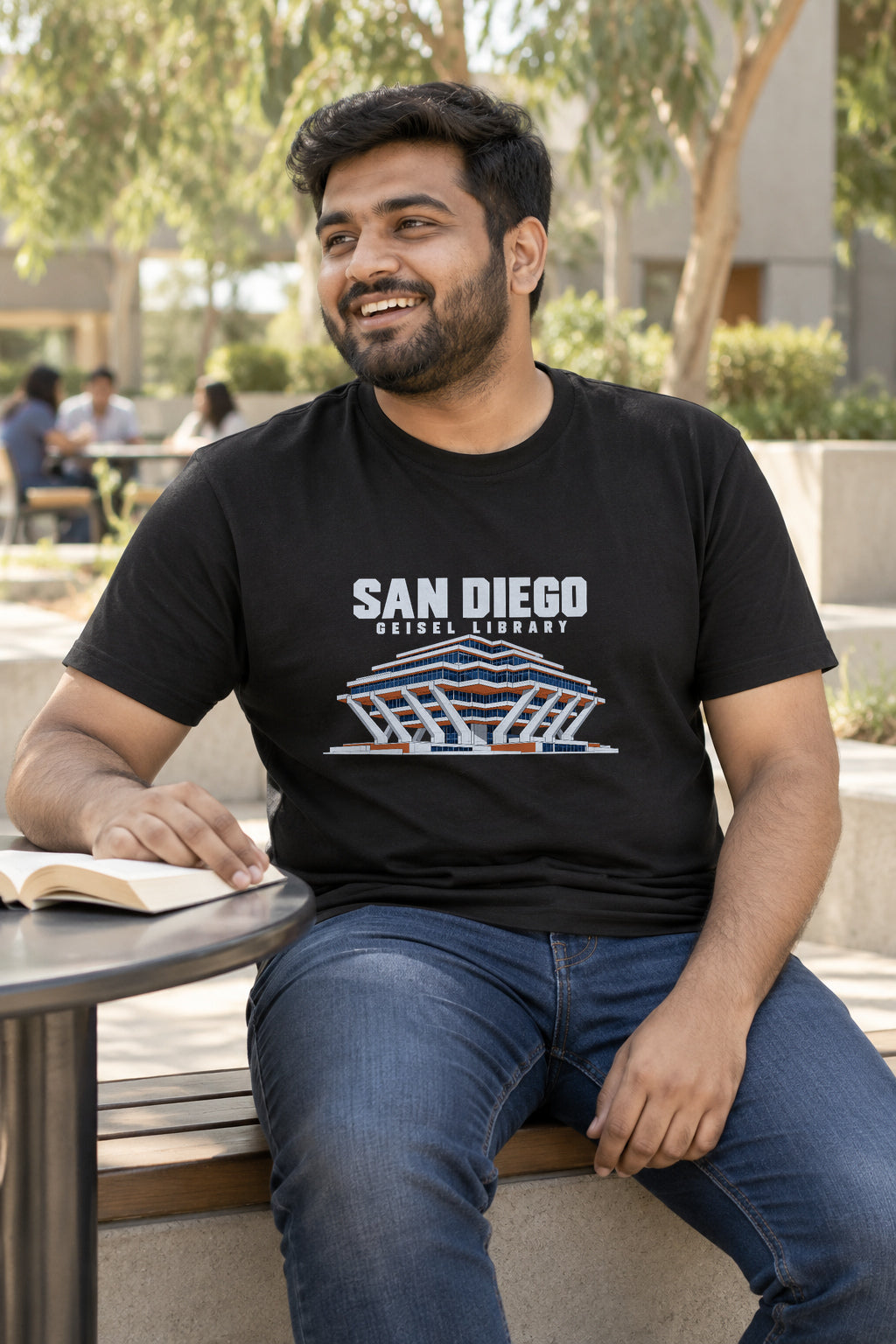 Illustrative lifestyle mockup of the Geisel Library San Diego Architecture T-Shirt on a black shirt in a generated scene.