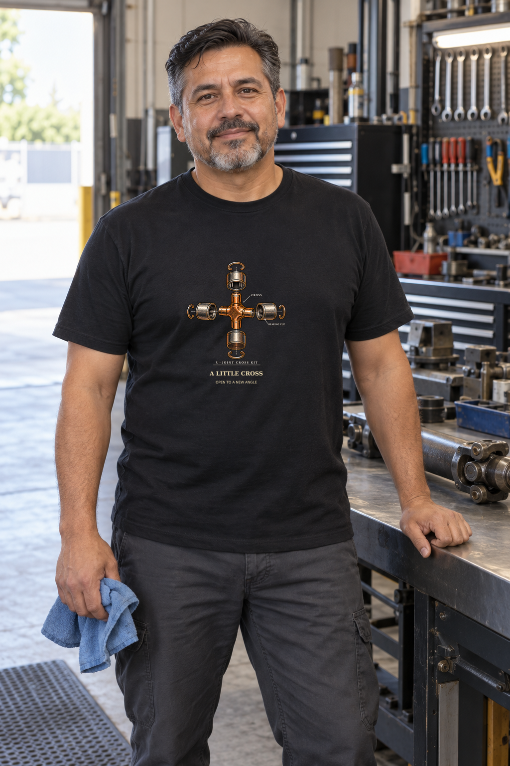 Illustrative lifestyle mockup of the A Little Cross U-Joint Mechanical Engineering T-Shirt on a black shirt in a generated scene.